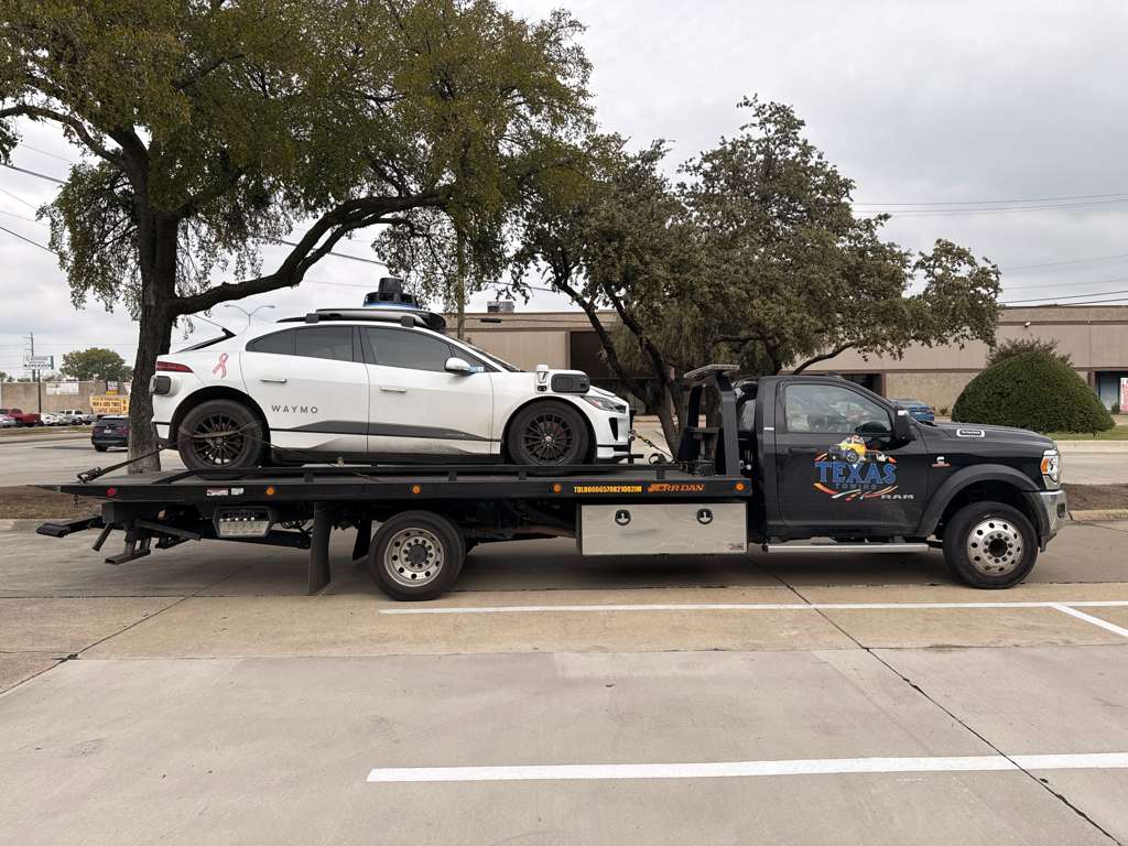 Texas Towing flatbed carrying a vehicle
